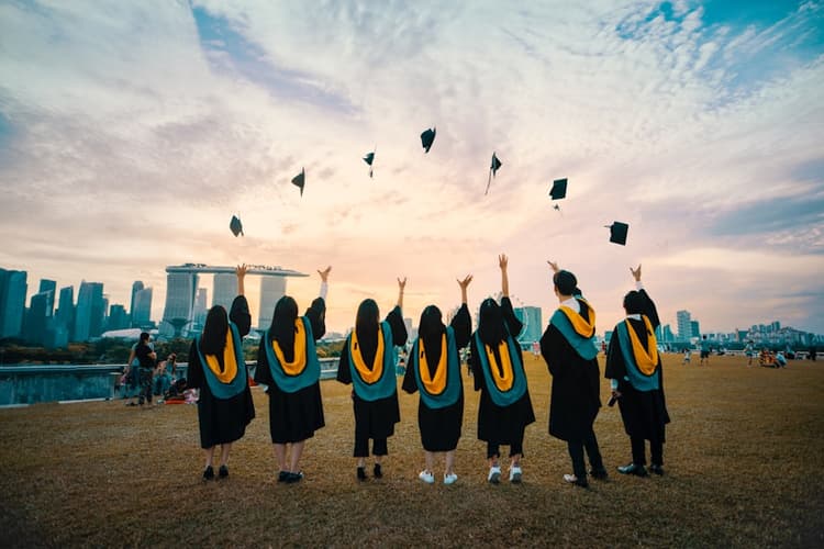 Nigerian graduates celebrating in convocation gowns